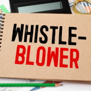 Book about Whistleblower isolated on wooden table.